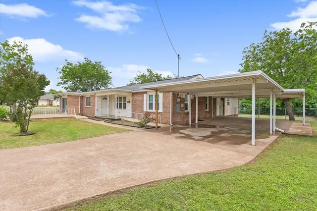 a view of a house with a yard and sitting area