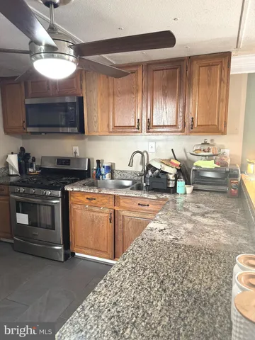 a kitchen with a sink and a stove top oven