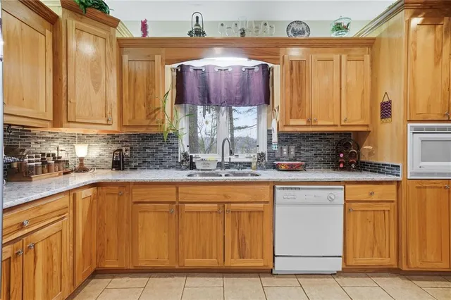 a kitchen with stainless steel appliances granite countertop a sink and cabinets