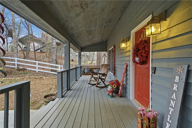 a view of a balcony with chairs and wooden floor