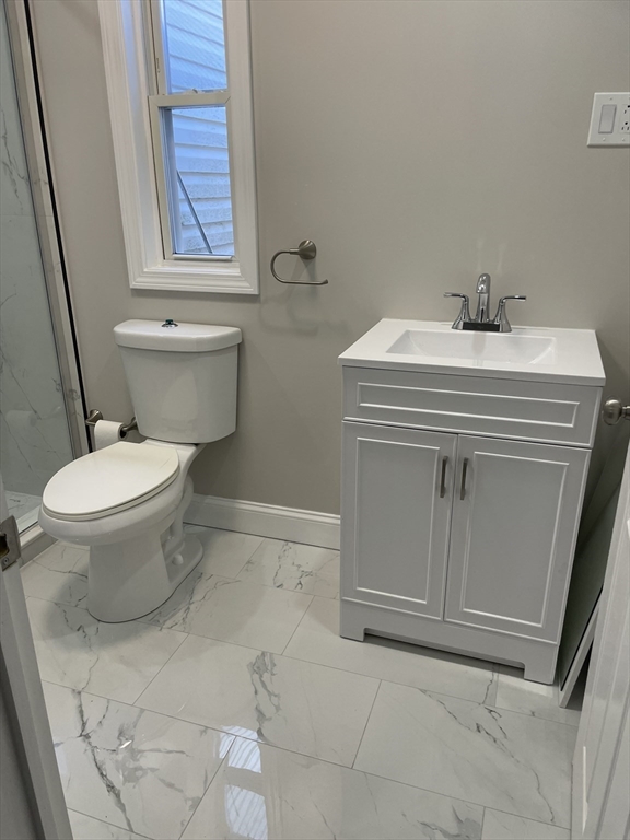 58 Mt Hope Street, Unit 1 Boston, MA 02131 - Photo 7 of 8 a bathroom with a sink toilet and window