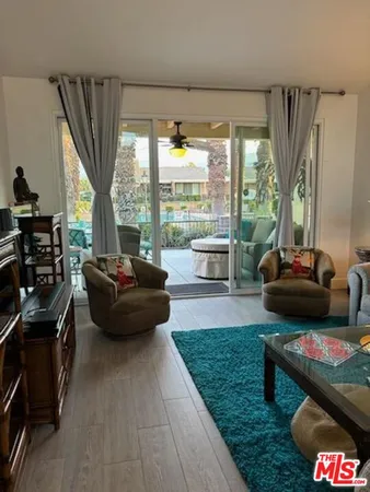 a living room with furniture and a floor to ceiling window