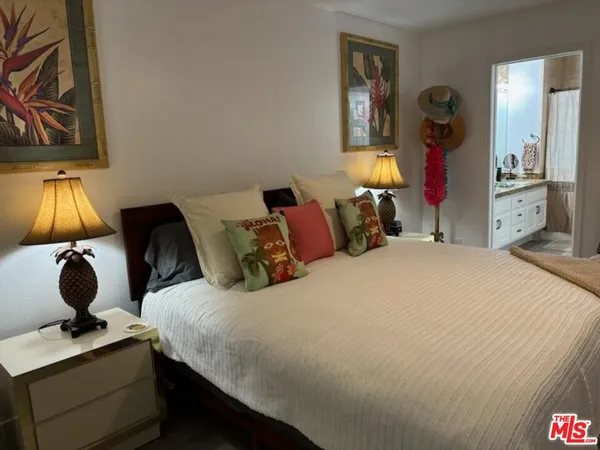 a bedroom with a bed and a mirror