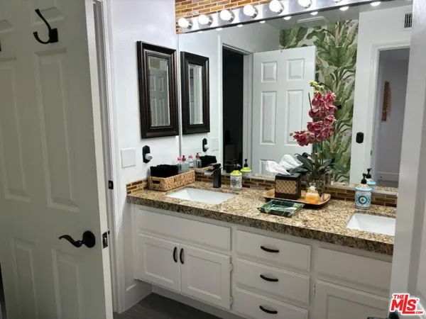 a bathroom with a double vanity sink and mirror