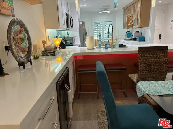 a kitchen with a sink a stove a washer dryer and a dining table