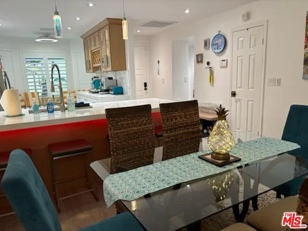 a kitchen with a table chairs stove and cabinets