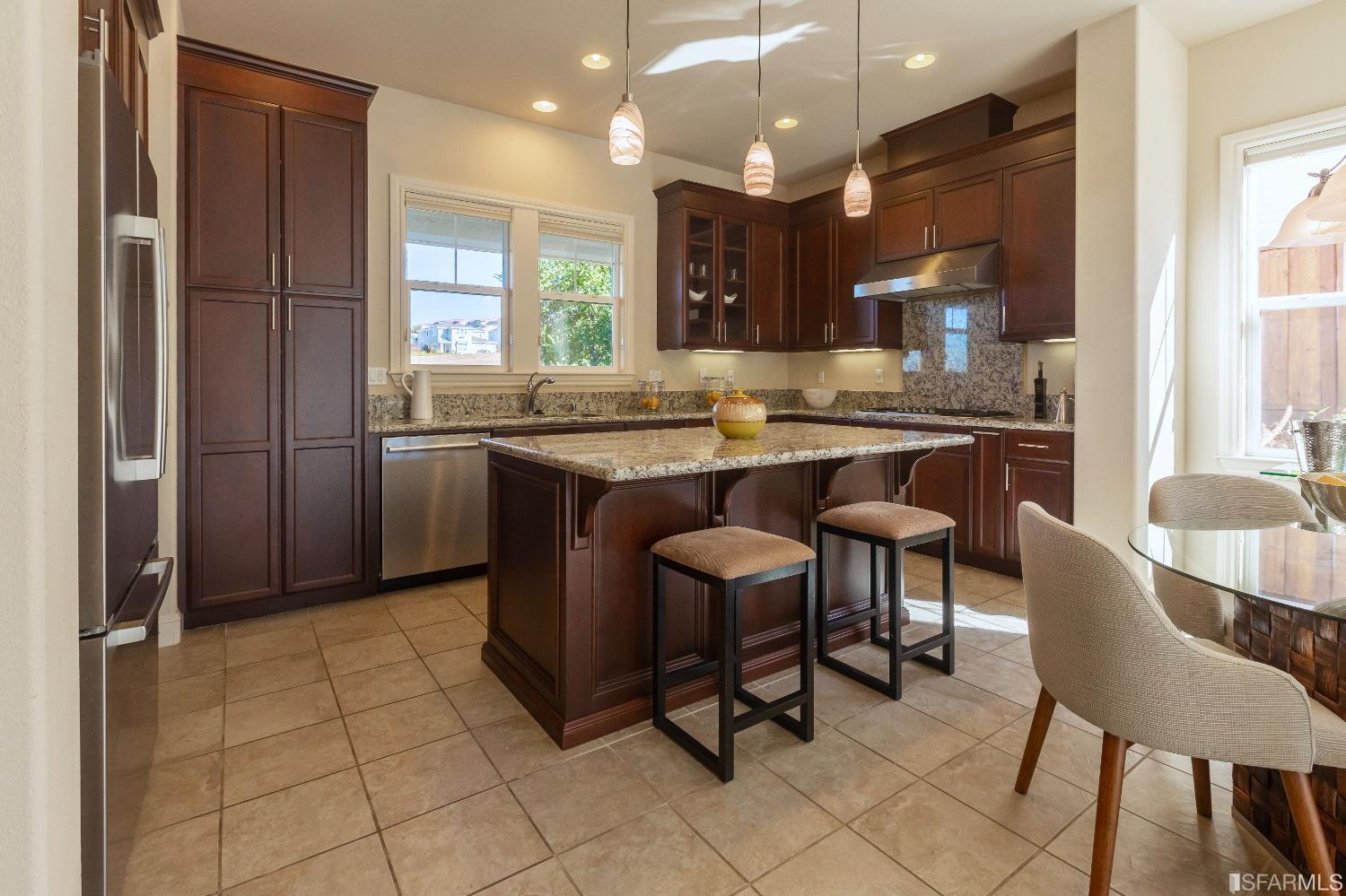 4456 Sunset View Drive Dublin, CA 94568 - Photo 4 of 40 a kitchen with stainless steel appliances granite countertop a sink a stove a refrigerator and chairs
