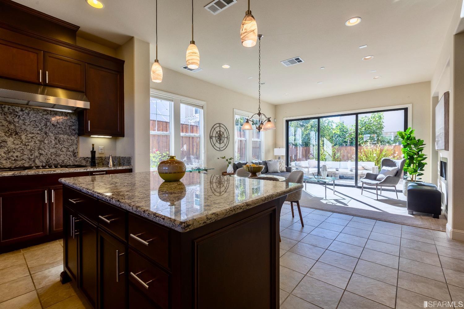 4456 Sunset View Drive Dublin, CA 94568 - Photo 5 of 40 a kitchen with stainless steel appliances granite countertop a sink a counter space and a view of living room