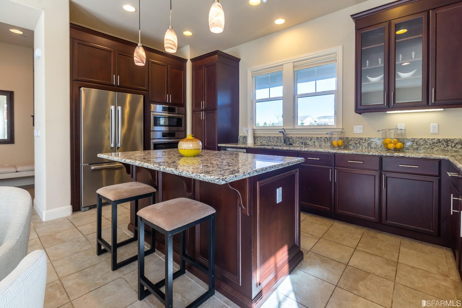 4456 Sunset View Drive Dublin, CA 94568 - Photo 6 of 40 a kitchen with stainless steel appliances granite countertop a sink a stove a refrigerator and chairs