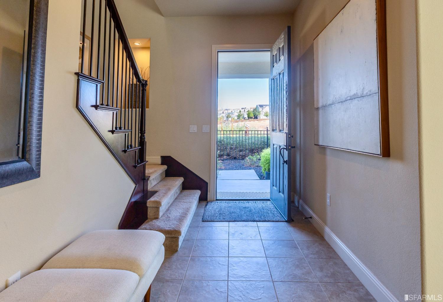 4456 Sunset View Drive Dublin, CA 94568 - Photo 10 of 40 a hallway with two couches and a dining table with wooden floor