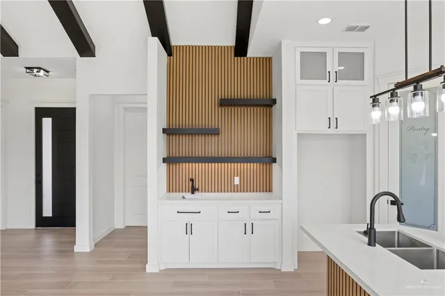 a kitchen with a refrigerator and a sink