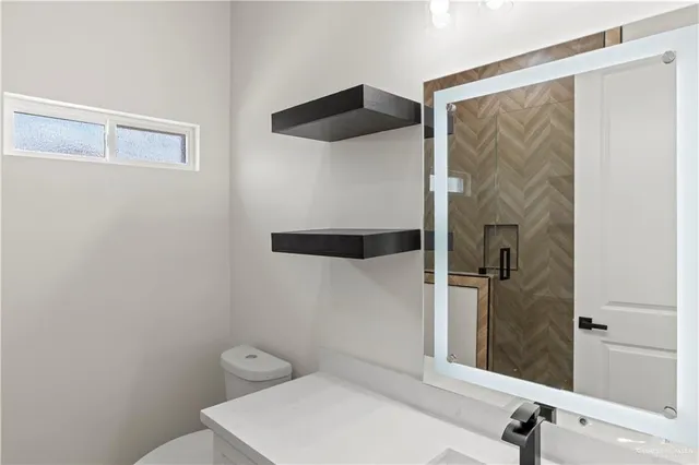 a bathroom with a toilet and a shower curtain