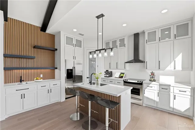 a kitchen with a sink stove and cabinets