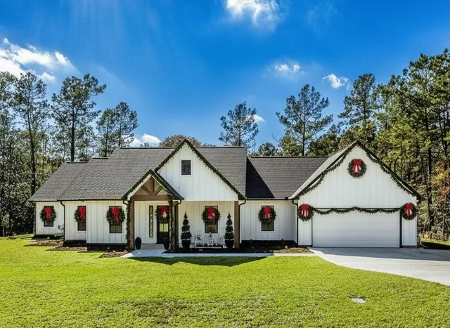 a view of a house with pool and sitting area