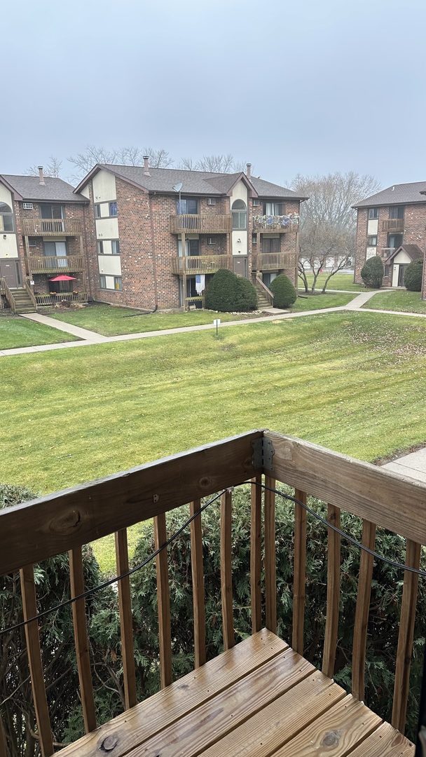 413 Berkshire Drive, Unit 22 Crystal Lake, IL 60014 - Photo 11 of 14 a view of a house with a yard from a balcony