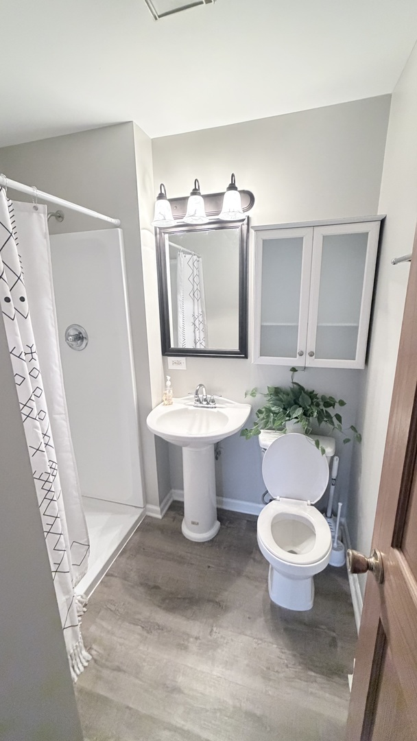 413 Berkshire Drive, Unit 22 Crystal Lake, IL 60014 - Photo 6 of 14 a bathroom with a toilet sink and mirror