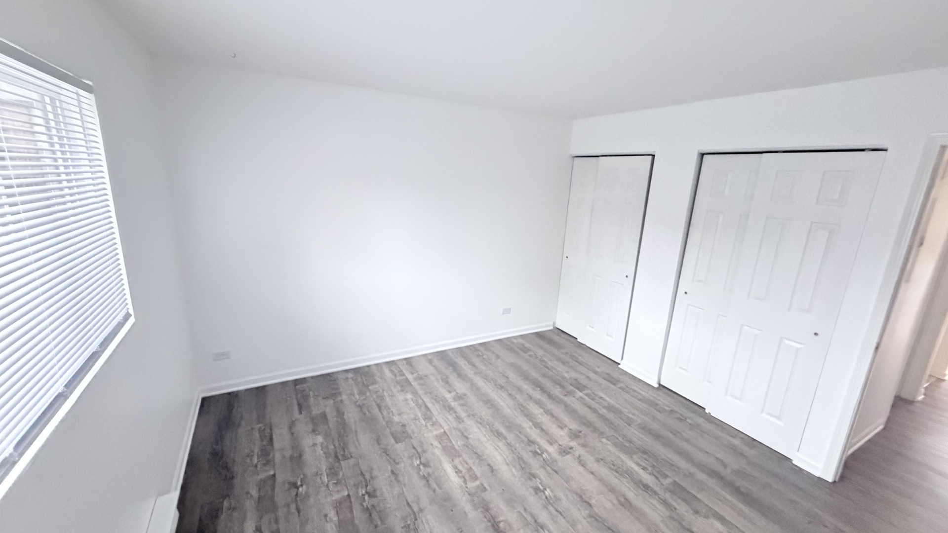 413 Berkshire Drive, Unit 22 Crystal Lake, IL 60014 - Photo 9 of 14 a view of an empty room with wooden floor and a window