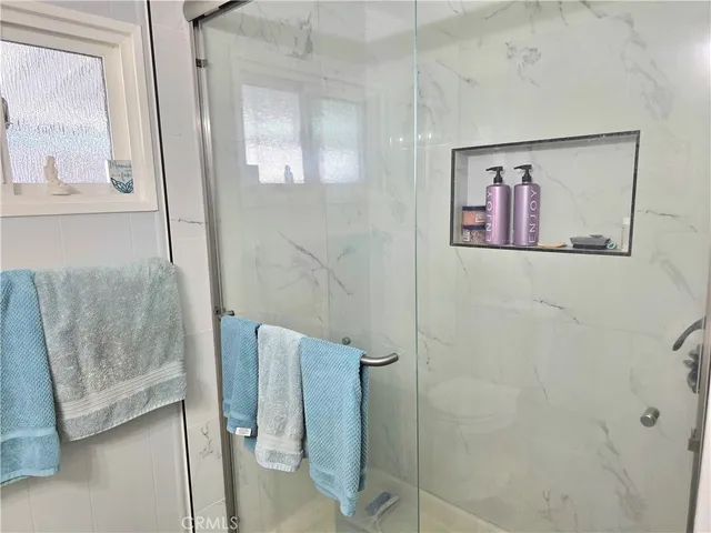 a bathroom with a sink a toilet and window