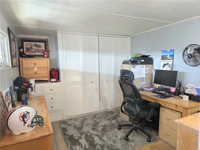 a view of a workspace with furniture and gym equipment