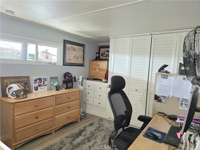 a bathroom with a granite countertop toilet sink and mirror