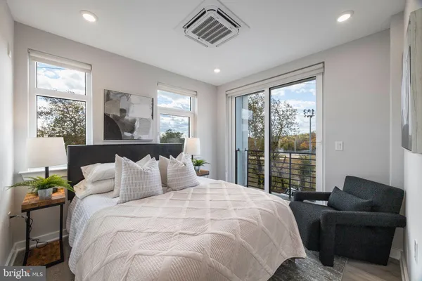 a bedroom with a large bed and a window