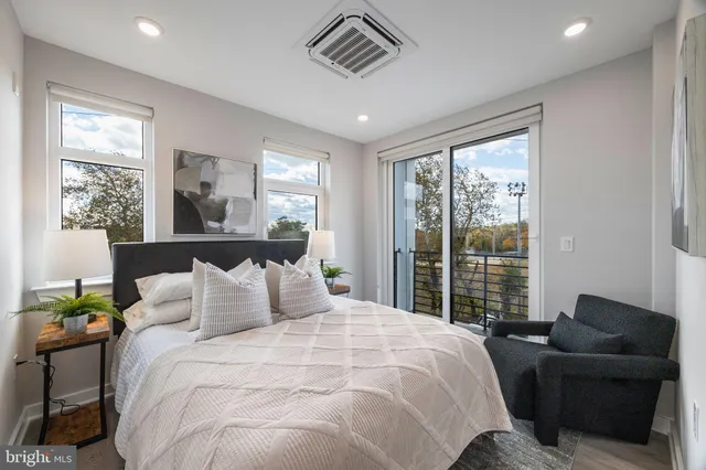 a bedroom with a large bed and a window