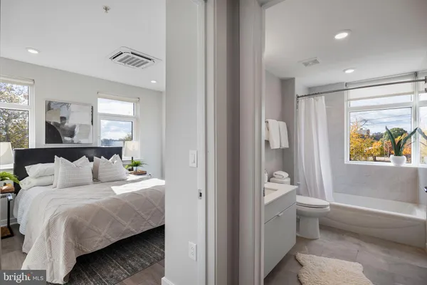a bedroom with a bed and a painting on the wall