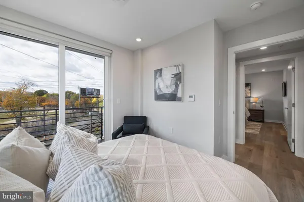 a bedroom with a large bed and a balcony