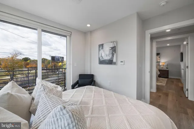 a bedroom with a large bed and a balcony
