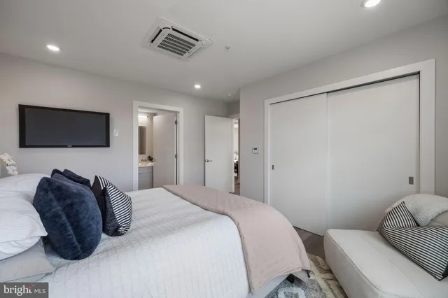 a bedroom with a bed and a television