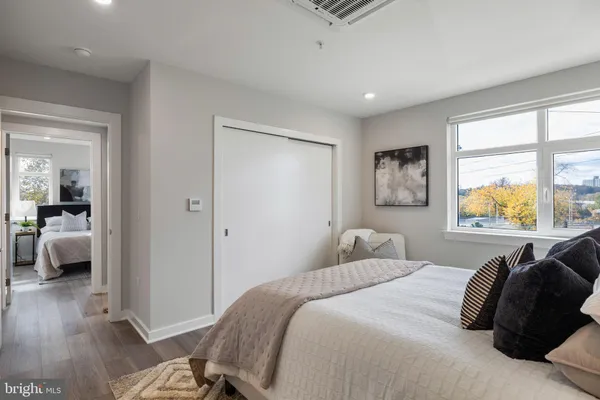 a bedroom with a bed and wooden floor