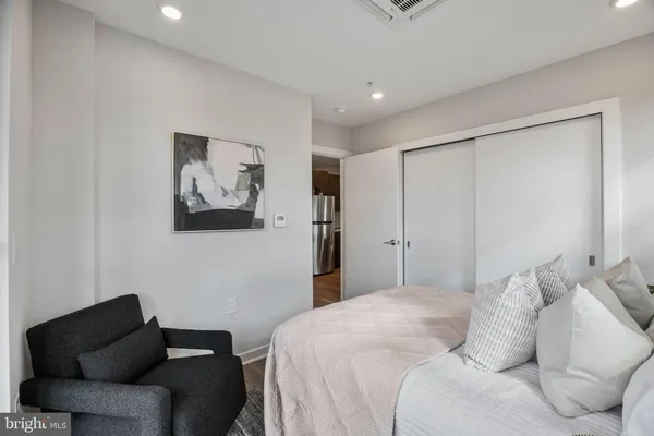 a bedroom with a bed and a couch