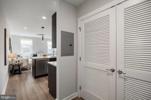 a kitchen view with furniture and wooden floor