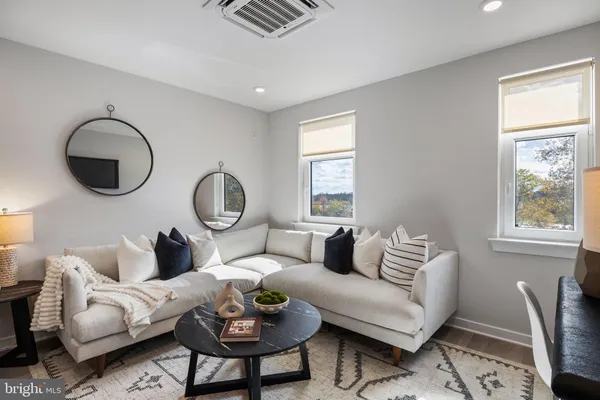 a living room with furniture a table and a window
