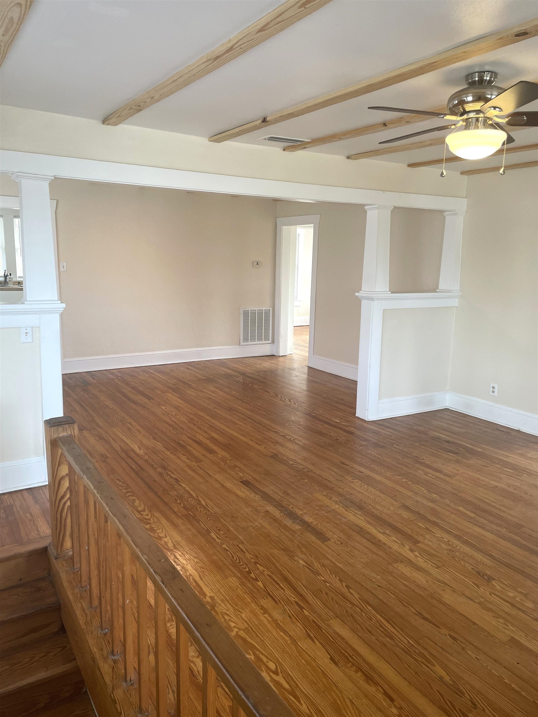 143 A Riberia Street St. Augustine, FL 32084 - Photo 5 of 11 Spare room with dark wood-type flooring, a ceiling fan, and beamed ceiling