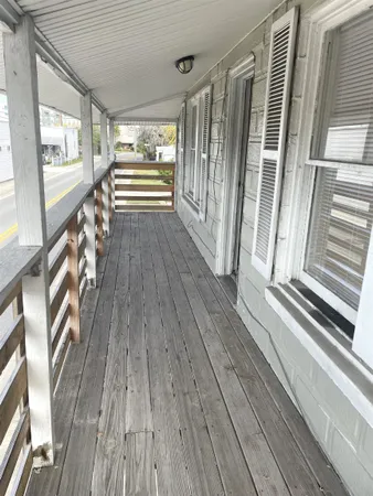 a view of front door with wooden floor and furniture