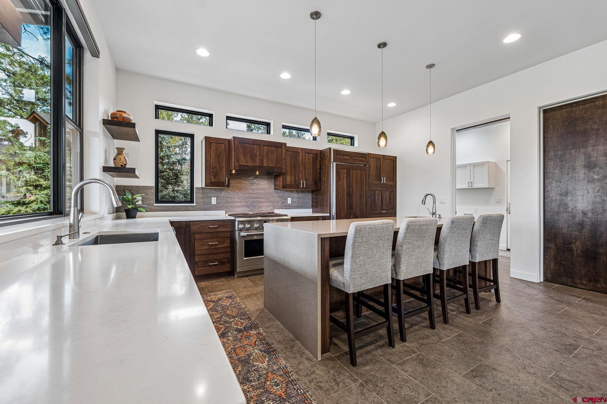 201 Window Lake Trail Durango, CO 81301 - Photo 15 of 45 a large kitchen with a table and chairs