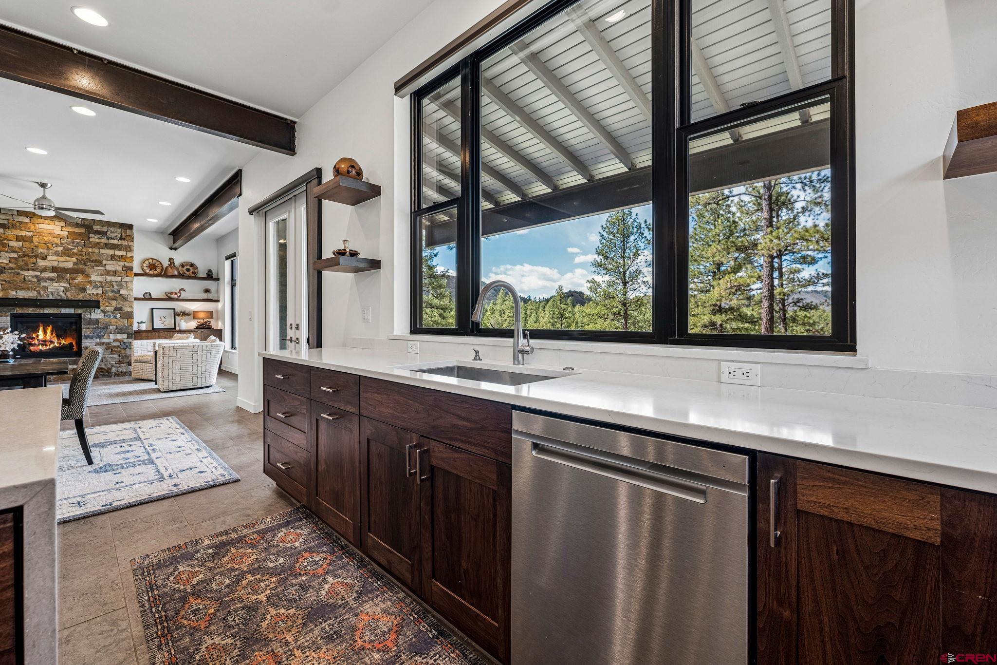 201 Window Lake Trail Durango, CO 81301 - Photo 17 of 45 a large kitchen with stainless steel appliances wooden cabinets and a large window