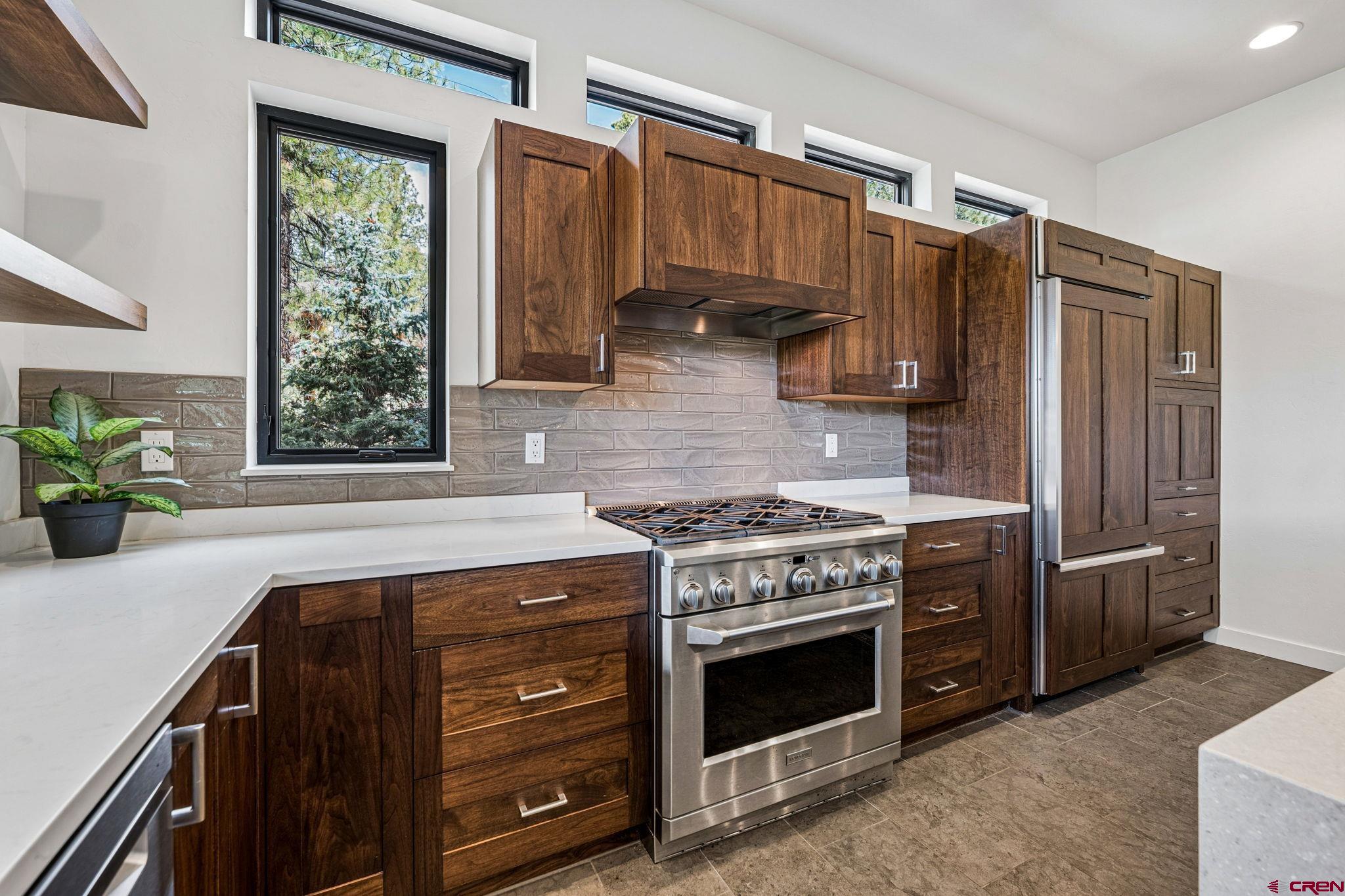 201 Window Lake Trail Durango, CO 81301 - Photo 18 of 45 a kitchen with stainless steel appliances granite countertop a stove a refrigerator and a sink