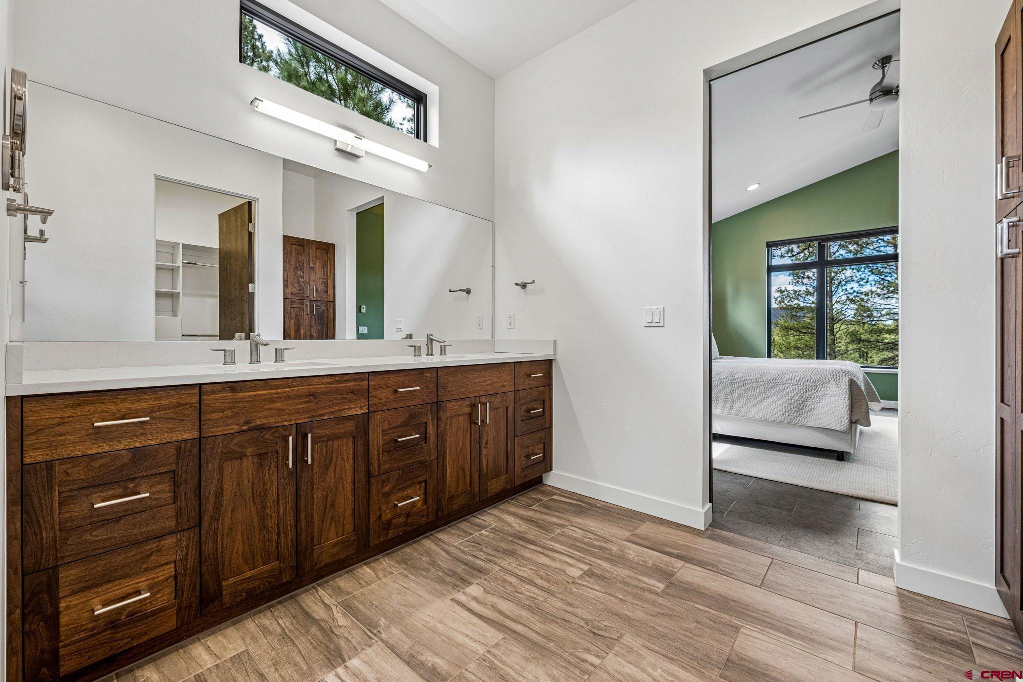 201 Window Lake Trail Durango, CO 81301 - Photo 23 of 45 a spacious bathroom with a granite countertop sink and a mirror