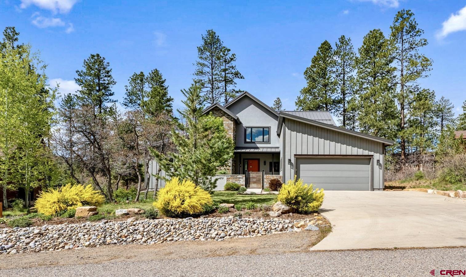 201 Window Lake Trail Durango, CO 81301 - Photo 3 of 45 a front view of a house with a garden