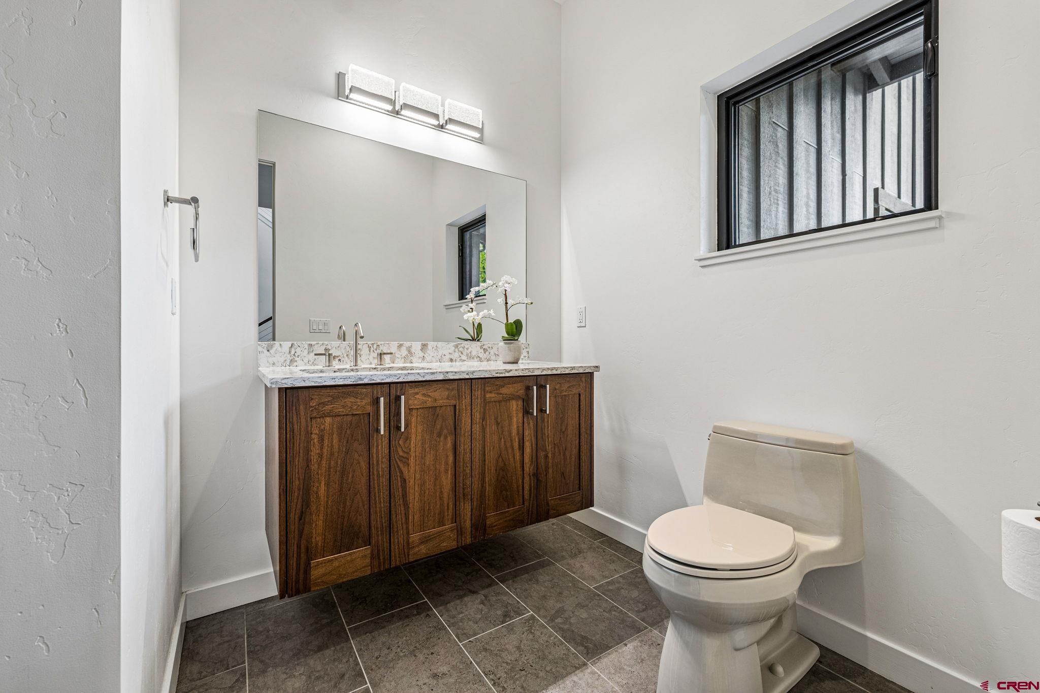 201 Window Lake Trail Durango, CO 81301 - Photo 7 of 45 a bathroom with a toilet a sink and mirror