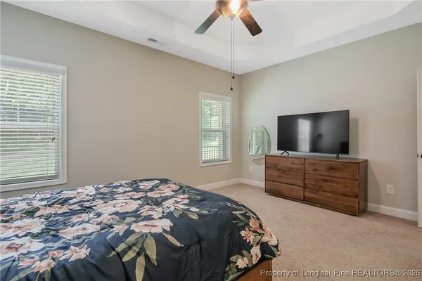 a bedroom with bed and flat screen tv