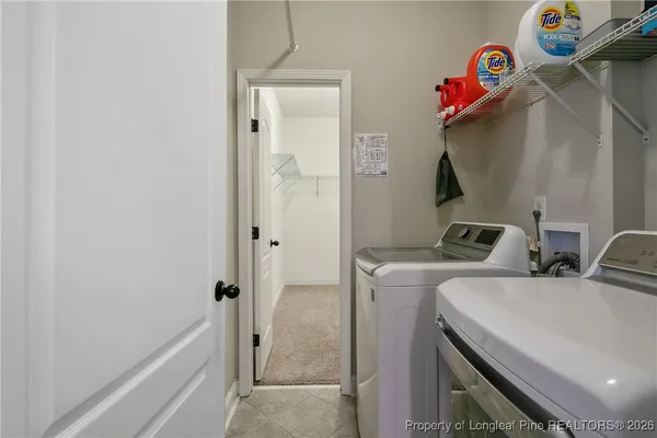 a view of a hallway with washer and dryer