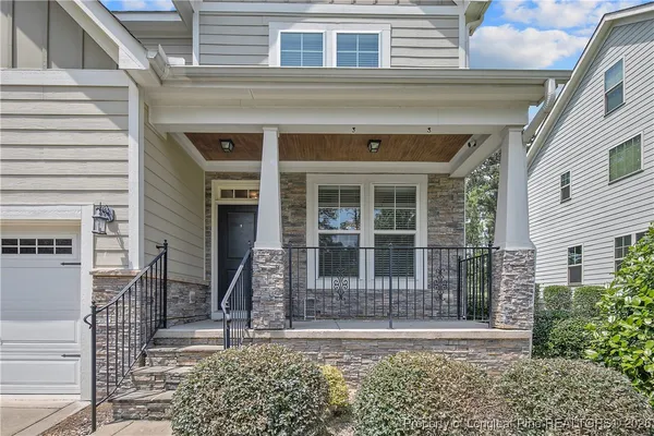 a front view of a house with a garden