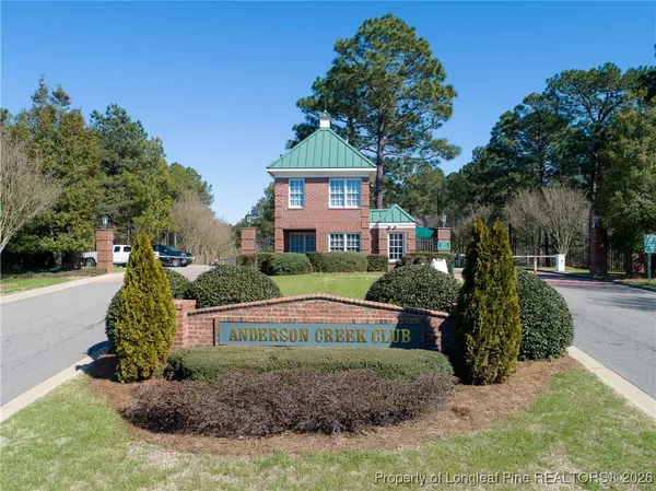 an aerial view of residential house with outdoor space and trees all around