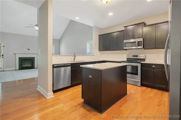 a kitchen with stainless steel appliances granite countertop a sink stove and microwave