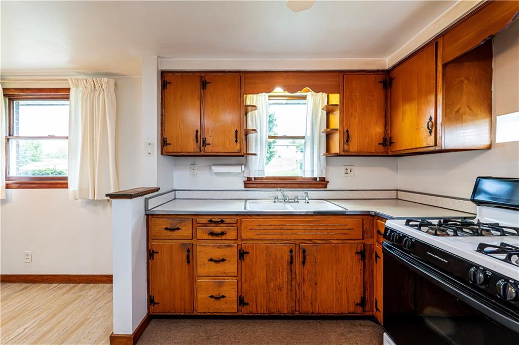 13740 Ridge Road Irwin, PA 15642 - Photo 13 of 43 a kitchen with wooden floor and a stove top oven