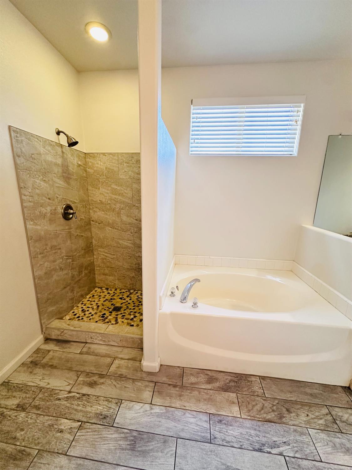6642 East Cetti Avenue Fresno, CA 93727 - Photo 13 of 18 a bathroom with a bathtub and shower