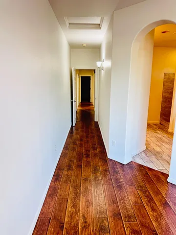 a view of a hallway with wooden floor